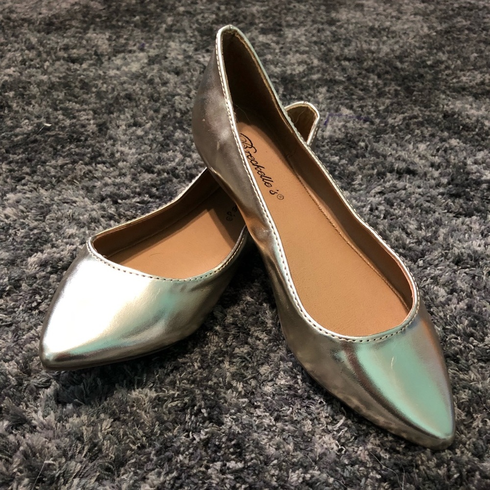 Gold flat shoes.